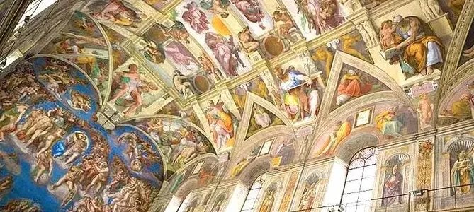 The ornate ceiling of the Sistine Chapel, showcasing Michelangelo’s Renaissance frescoes with vibrant colors and biblical scenes.