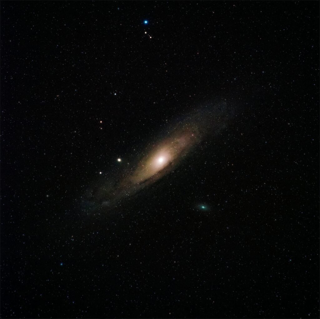 A photograph of the Andromeda Galaxy showcasing its bright core and spiral arms against the backdrop of space. Perfect for witnessing upcoming celestial events.