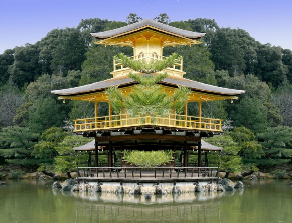 A traditional Japanese golden pavilion, known as Kinkaku-ji, reflected in a calm pond surrounded by lush greenery.