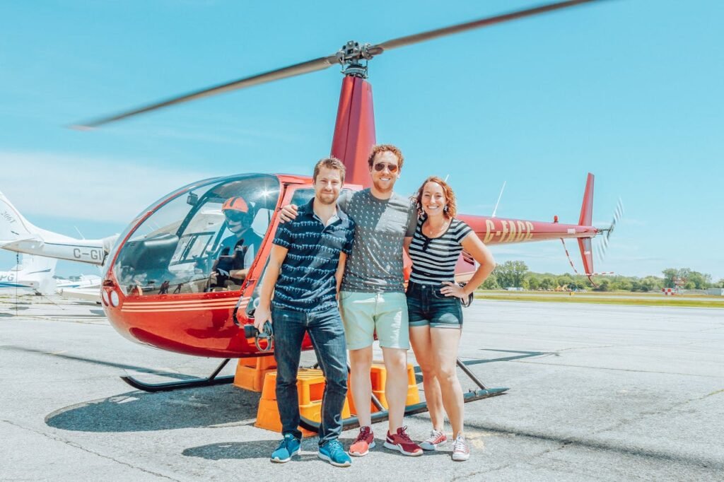 Happy travelers standing by a plane, ready for their surprise adventure.