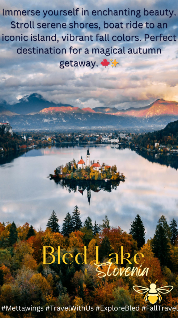 Aerial view of a small island with a church and several buildings, surrounded by a lake and autumn-colored trees, with mountains in the background at sunset.