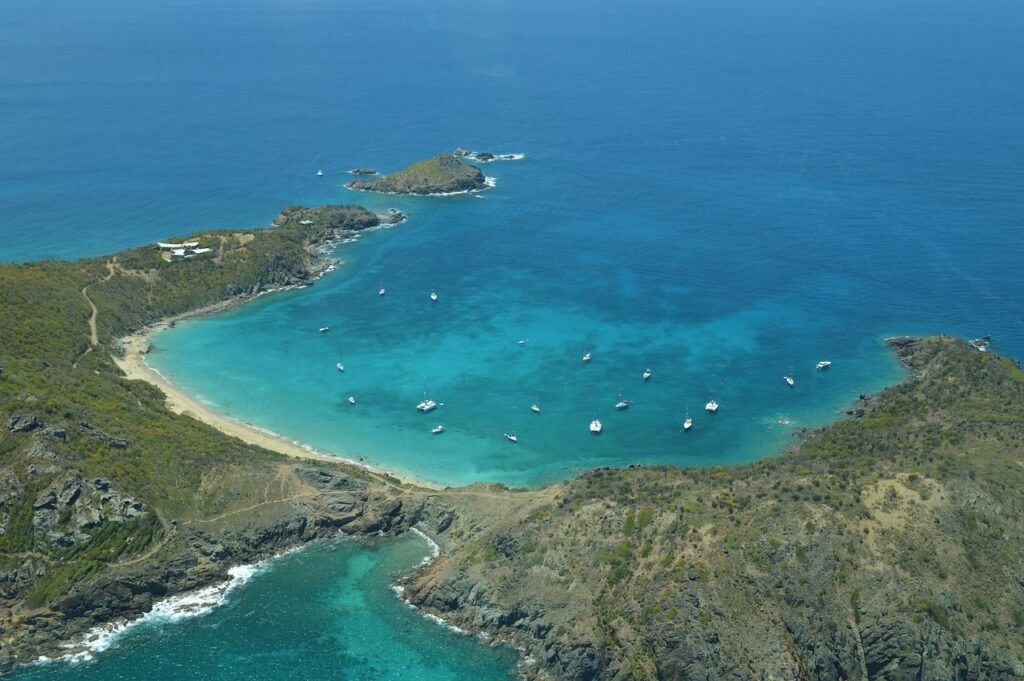 Aerial view of St. Barts coastline with turquoise waters and anchored boats. Caribbean and West Indies Vacation