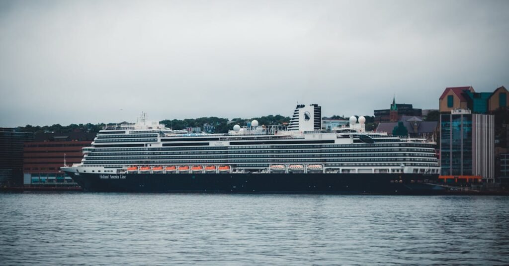 Holland America cruise ship docked at port under overcast skies.