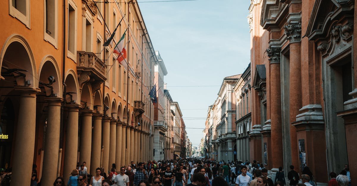 Unique travel destination Bologna with crowded pedestrian street and classical buildings. Crowd on Street in Bologna, Italy