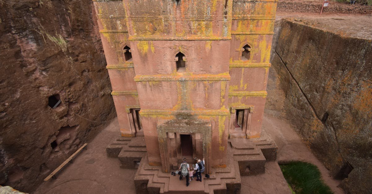 Unique travel destination Lalibela with the rock-hewn Church of Saint George. Family Visiting One of the Rock-Hewn Churches in Lalibela