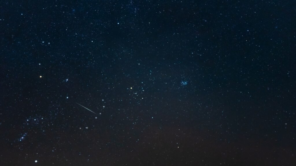 The Taurus constellation with a shooting star visible in the night sky. Upcoming Celestial Insights