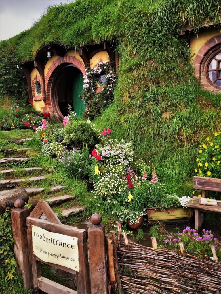 Bilbo's house in Middle-earth with a round green door and lush greenery