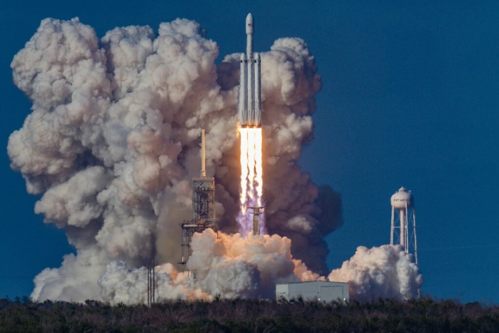 SpaceX rocket launching into space with a massive plume of smoke