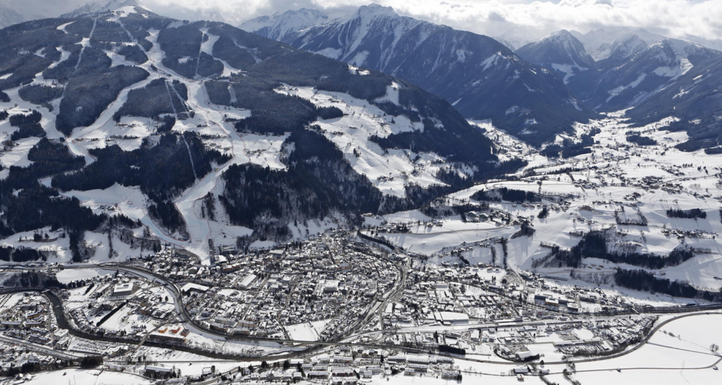 Snow-covered mountains of Schladming-Dachstein with the town of Ramsau am Dachstein nestled in the valley. Ski Austriav