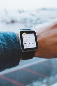 martwatch displaying a boarding pass at an airport showcasing Travel Tech Trends 2024